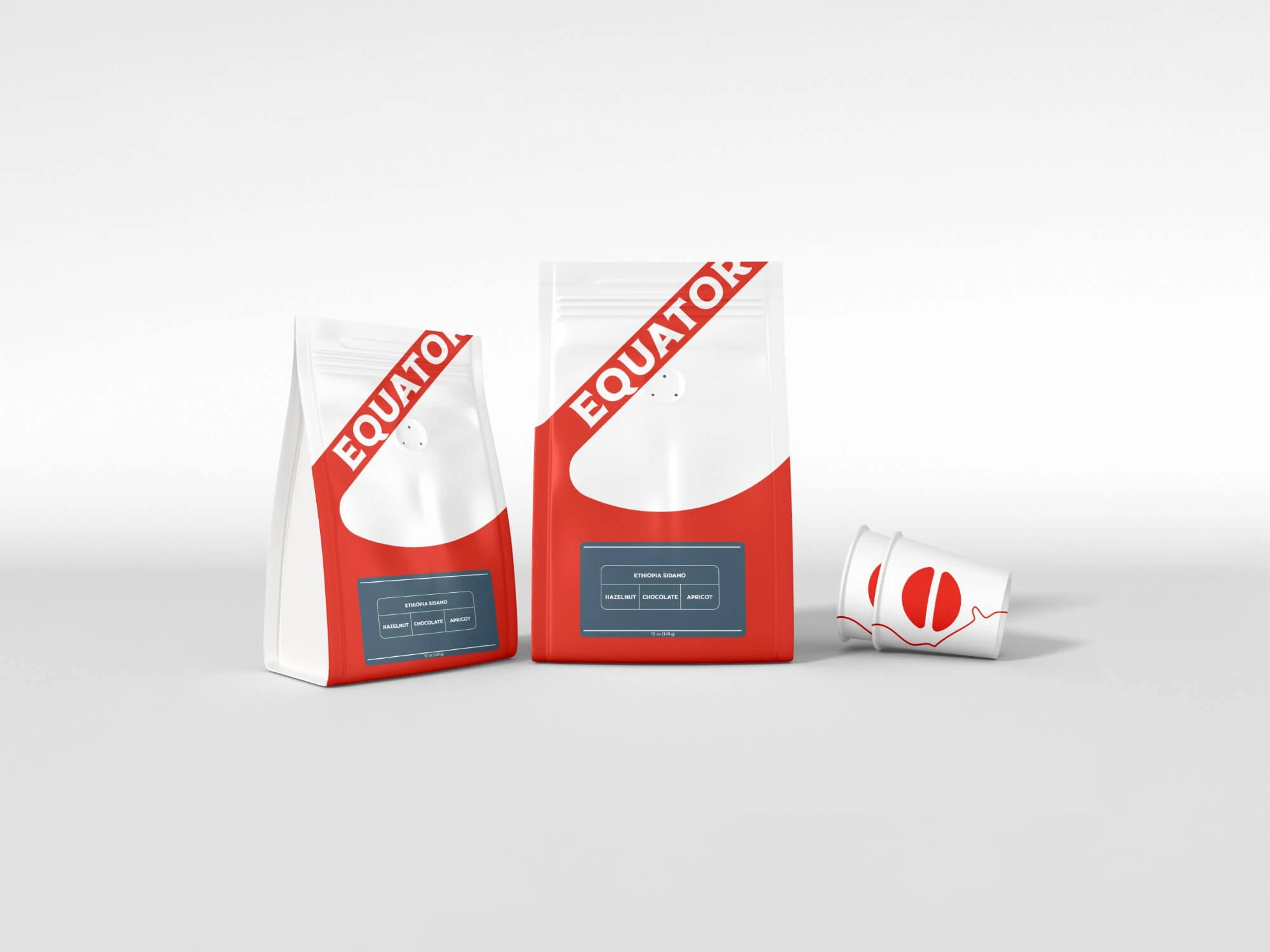 Equator Coffees branded packaging — whole bean bags and a paper cup